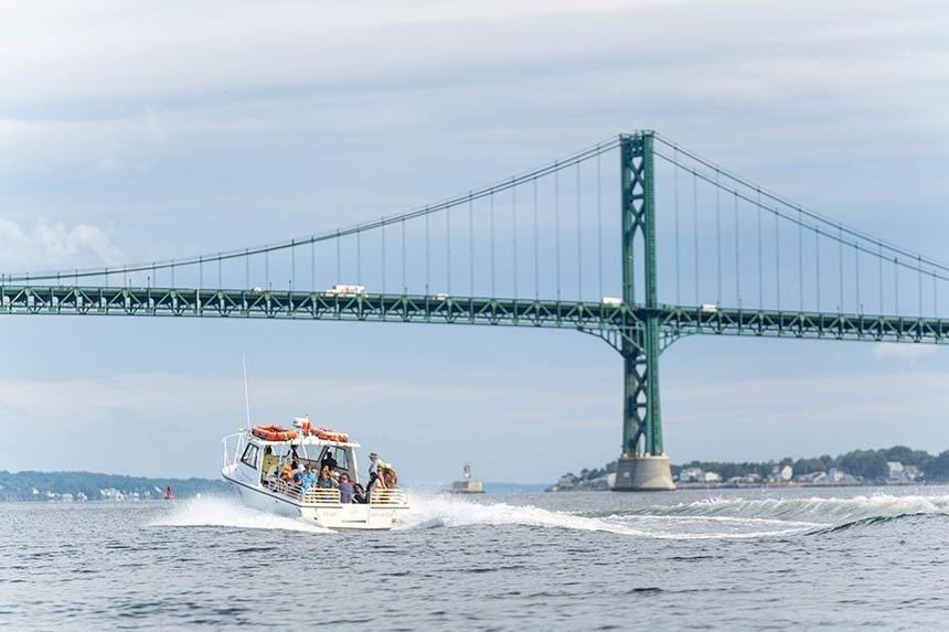 An image of the InVinceble Spirit research vessel going under the Mount Hope Bridge.